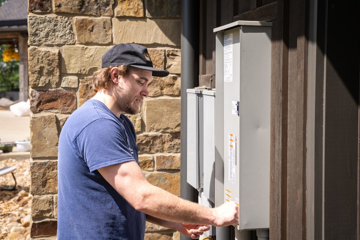 Outdoor meter base and main disconnect on a stone-clad home