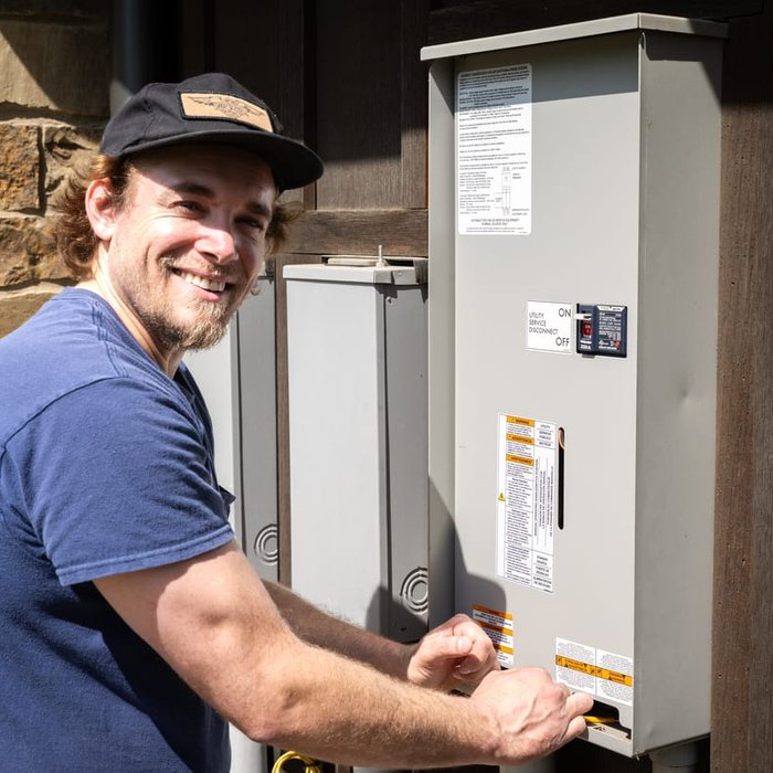 Greg, owner and master electrician, working on a service entrance panel